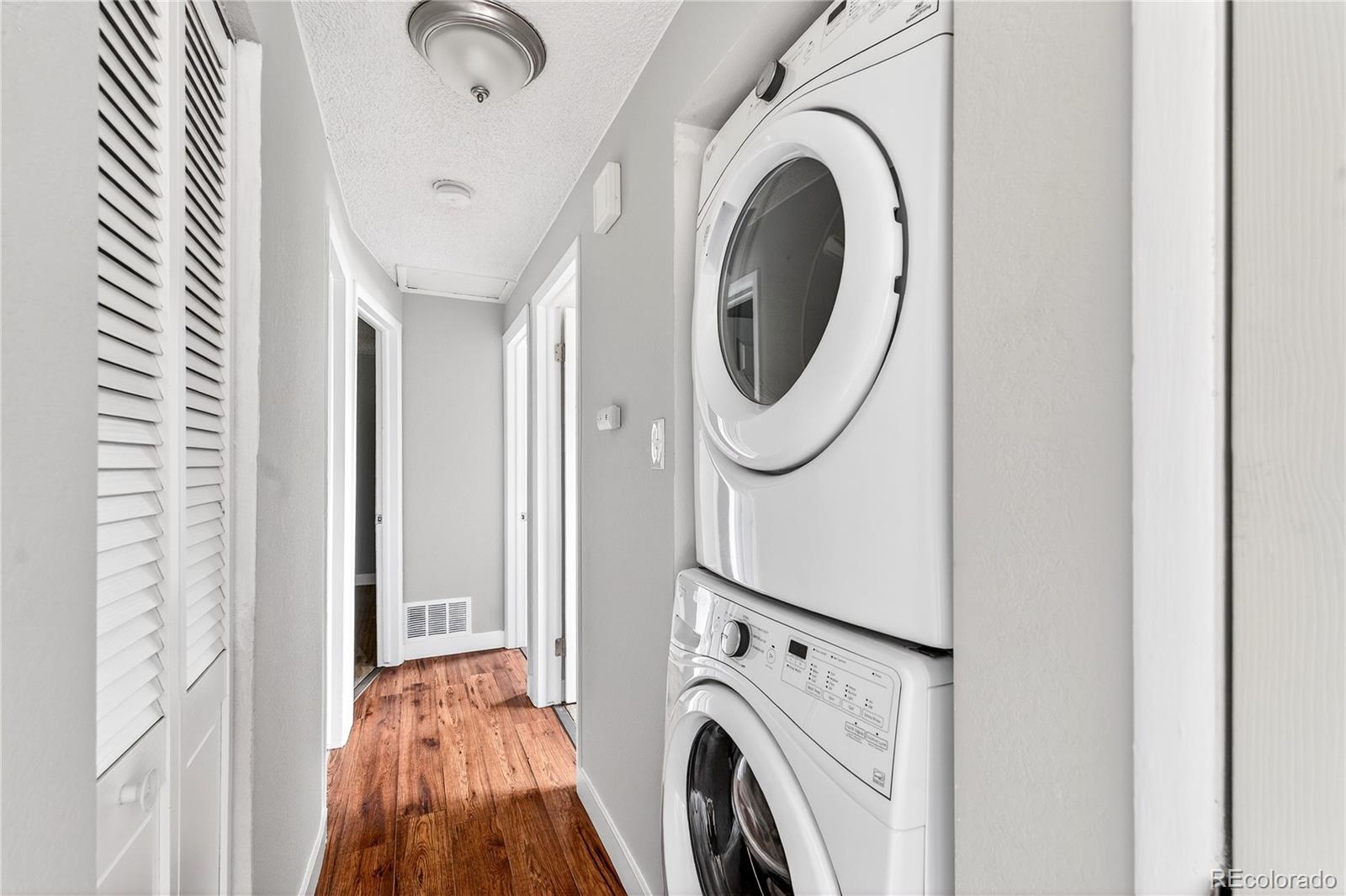 5246 Pierce Street Arvada, CO 80002 - Photo 23 of 30 a view of a hallway with washer and dryer