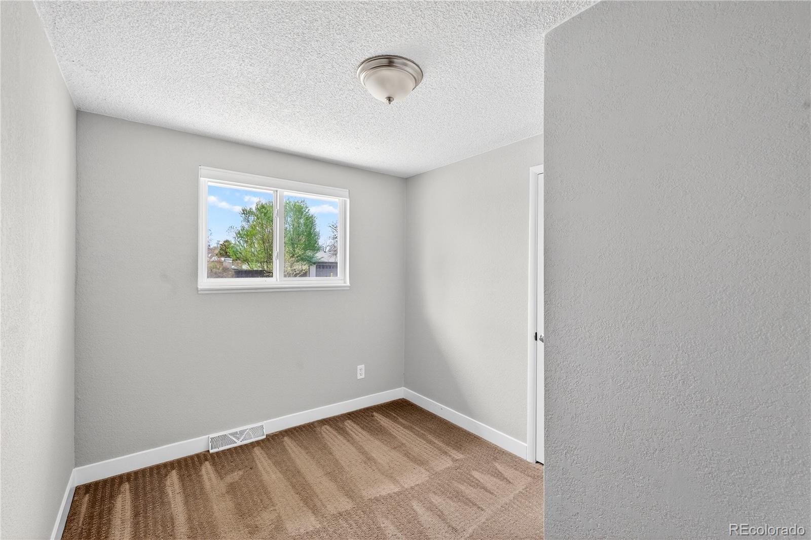 5246 Pierce Street Arvada, CO 80002 - Photo 26 of 30 a view of an empty room with window and closet