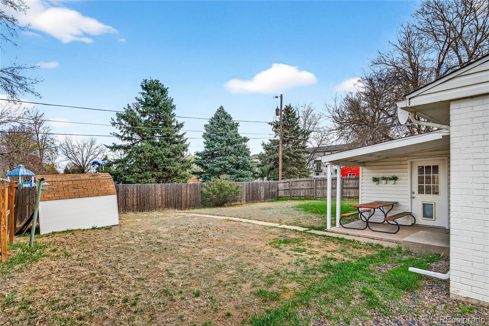 5246 Pierce Street Arvada, CO 80002 - Photo 28 of 30 a view of a white house and a yard