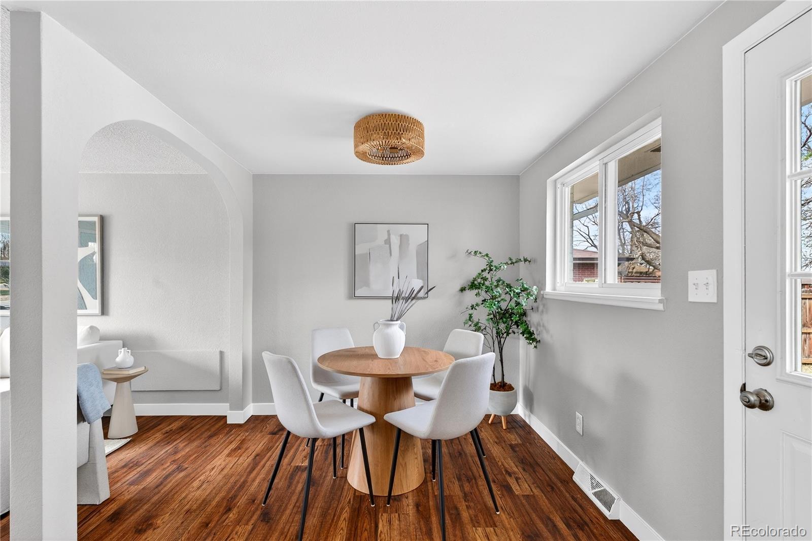 5246 Pierce Street Arvada, CO 80002 - Photo 7 of 30 a view of a dining room with furniture and wooden floor