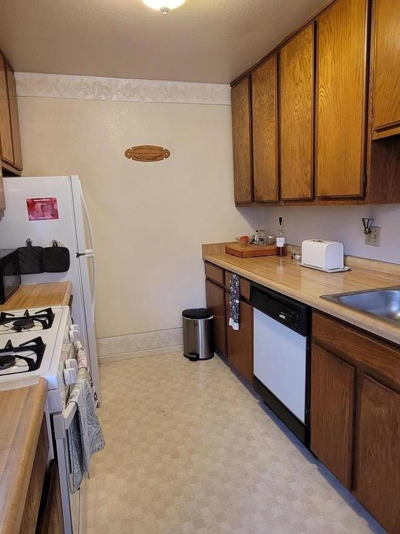 947 Ridgeview Court, Unit C South San Francisco, CA 94080 - Photo 12 of 26 a kitchen with a sink a stove and cabinets
