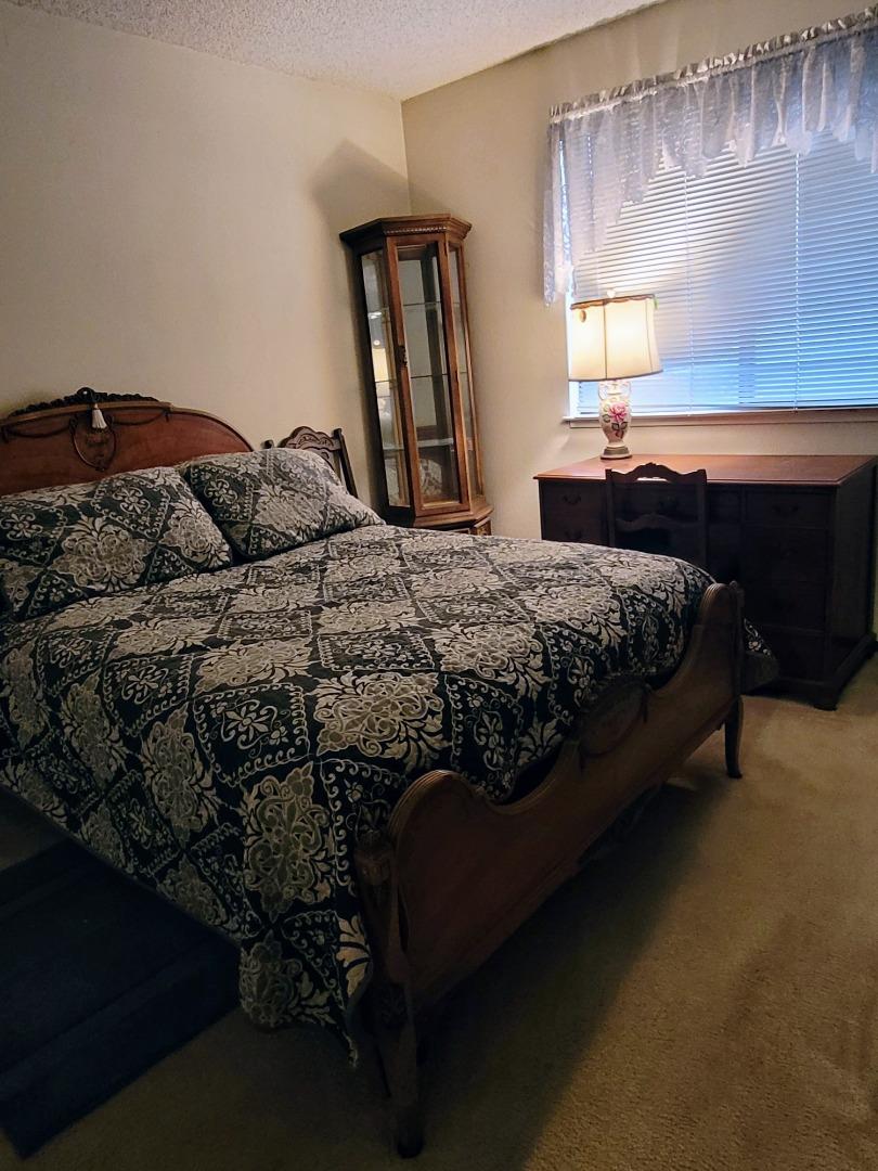 947 Ridgeview Court, Unit C South San Francisco, CA 94080 - Photo 20 of 26 a bedroom with a bed dresser and a window