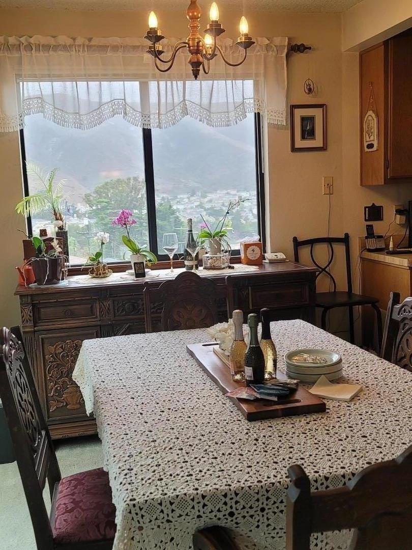 947 Ridgeview Court, Unit C South San Francisco, CA 94080 - Photo 7 of 26 a dining table with a fireplace and a large window