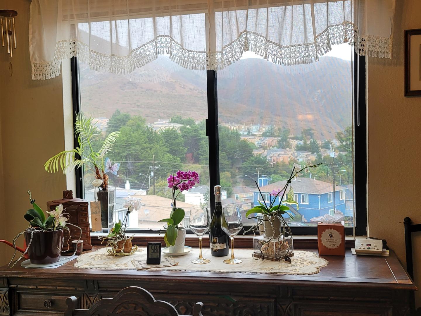 947 Ridgeview Court, Unit C South San Francisco, CA 94080 - Photo 8 of 26 a view of a sink with a vase of flowers sitting on a table