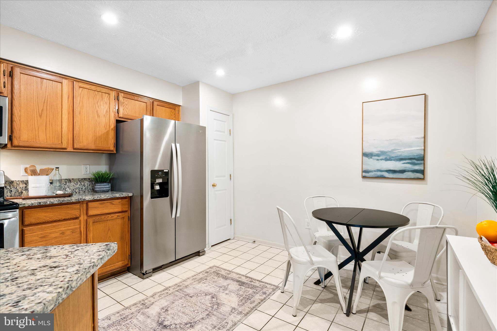 5306 Regal Court Frederick, MD 21703 - Photo 6 of 17 a kitchen with stainless steel appliances granite countertop a refrigerator and a stove top oven