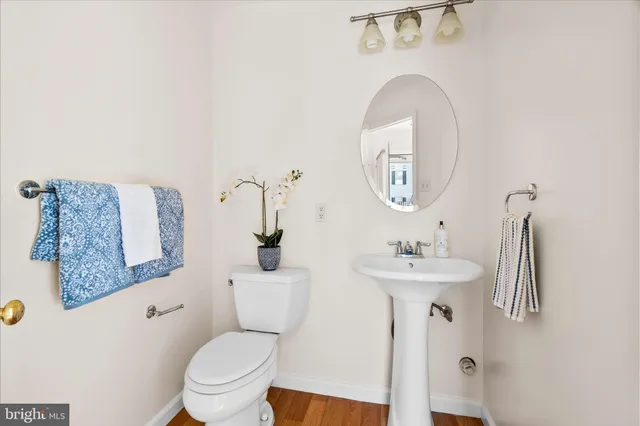 a bathroom with a toilet a sink and a mirror
