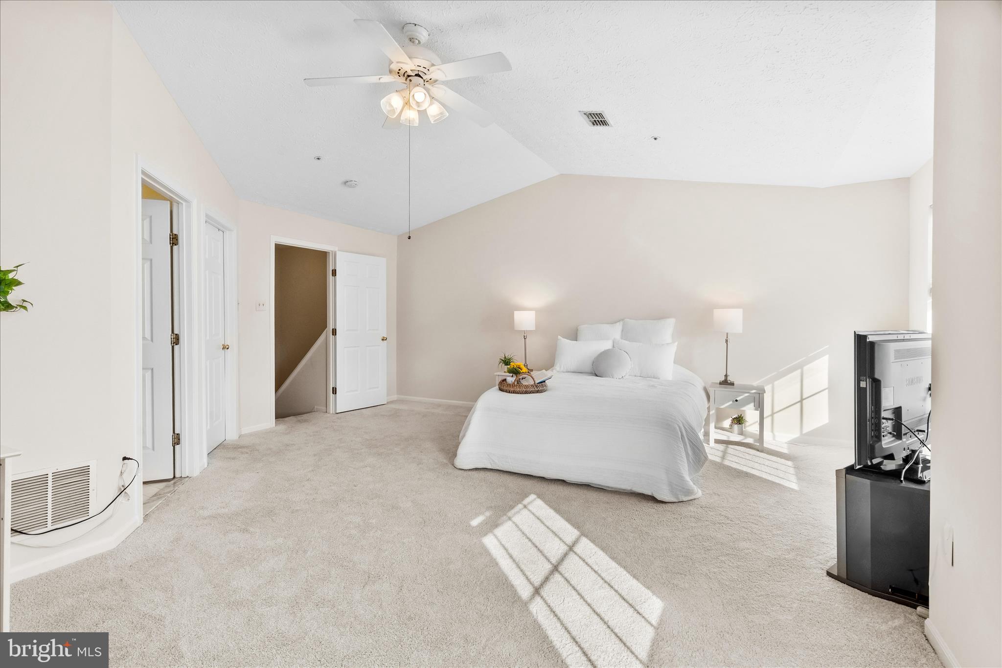 5306 Regal Court Frederick, MD 21703 - Photo 9 of 17 a bedroom with a bed and a chandelier