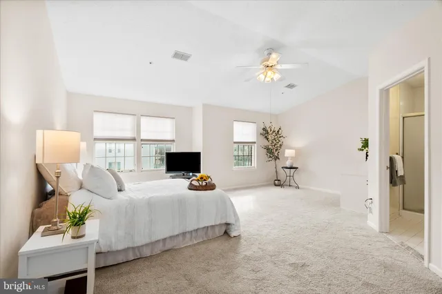 a bedroom with a bed couch and window