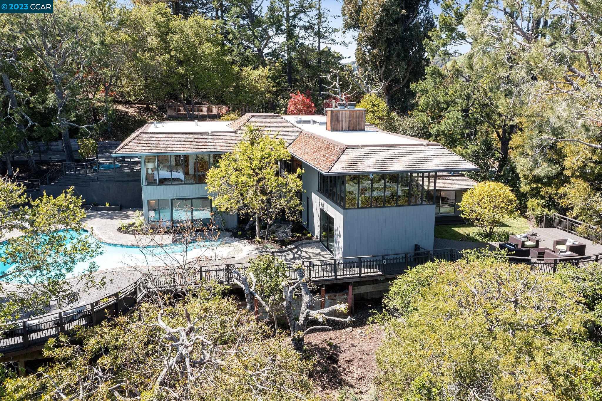 9 Rancho Diablo Road Lafayette, CA 94549 - Photo 1 of 1 a view of a patio with table and chairs under an umbrella