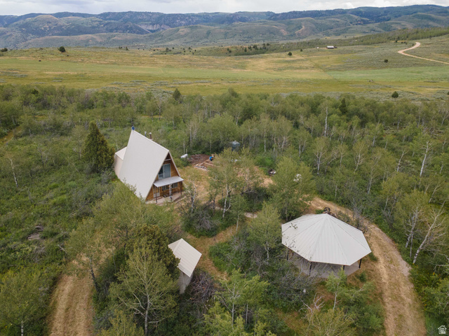 23 Scare Canyon, Unit 23 Logan, UT 84321 - Photo 1 of 33 A-frame structure with a pitched metal roof, featuring a wood-clad front facade and an exterior balcony