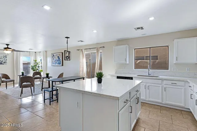 a kitchen with a refrigerator and a stove top oven