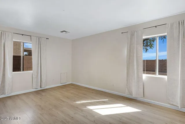 a view of a livingroom with a ceiling fan & wooden floor