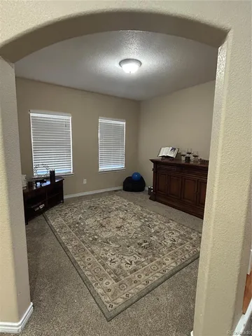 a view of a hallway with windows and stairs