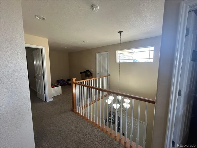 a room with furniture a flat screen tv and a window