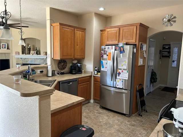 a kitchen with stainless steel appliances granite countertop a refrigerator and a sink
