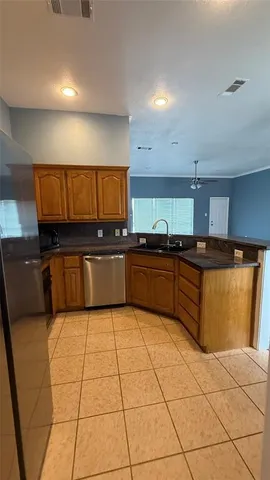 a large kitchen with stainless steel appliances and cabinets
