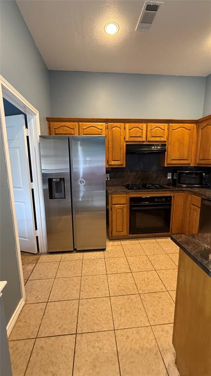124 Villanova Circle Forney, TX 75126 - Photo 2 of 14 a kitchen with stainless steel appliances a refrigerator a stove a sink and a counter top