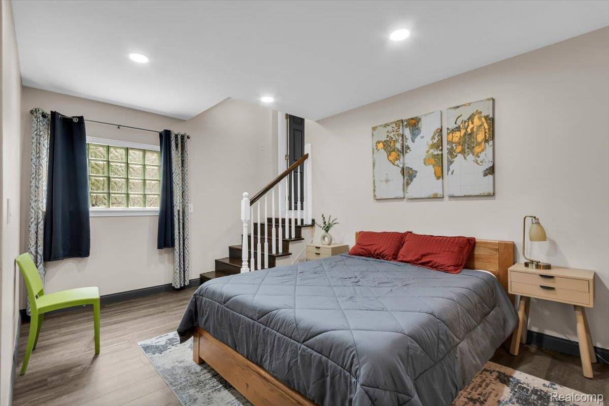 476 Touraine Road Grosse Pointe, MI 48236 - Photo 12 of 30 Recessed lighting, wood-finish flooring, glass block window, and a staircase with white balusters