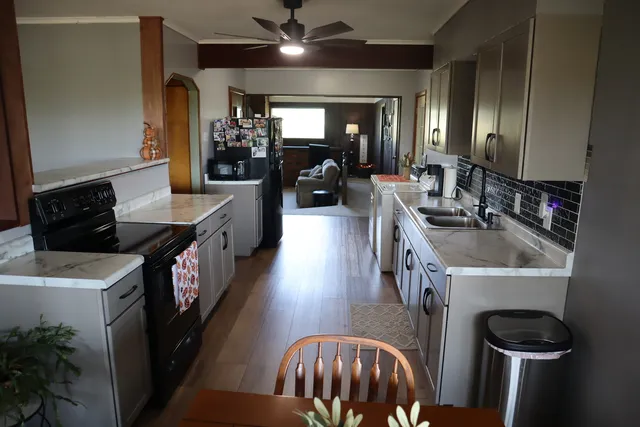 a kitchen with a sink a stove and a refrigerator
