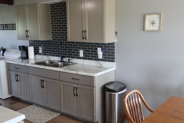 a kitchen with a sink cabinets and utility