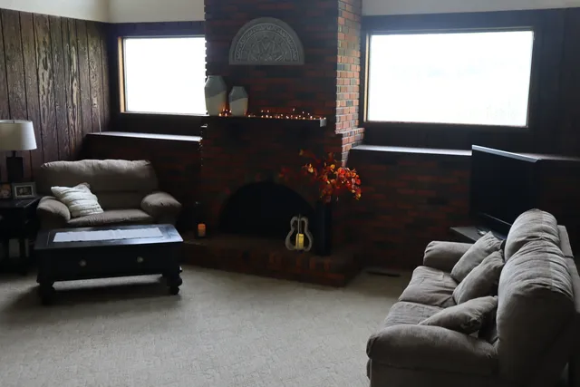 a living room with furniture a window and a flat screen tv