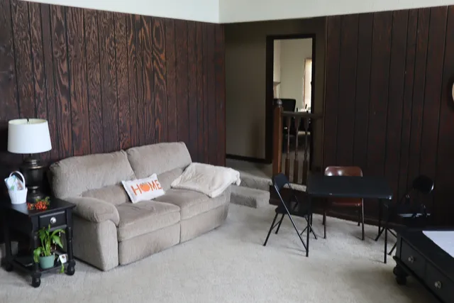 a living room with furniture and a lamp