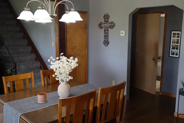 a view of a dining room with furniture and chandelier