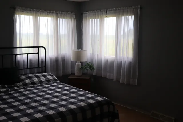 a bedroom with a bed and window