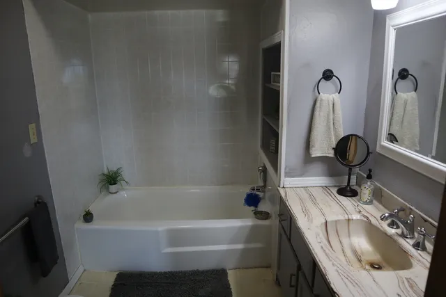 a living room with furniture and a lamp