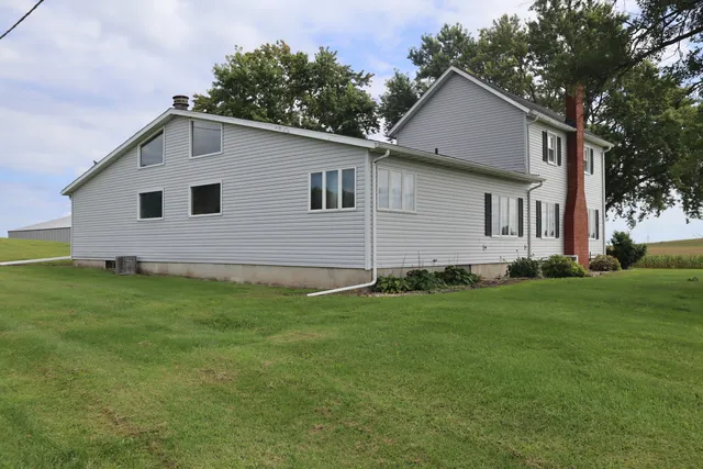 a front view of house with yard and green space