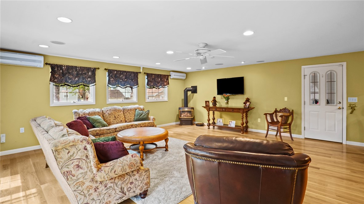 413 Spring Green Road Warwick, RI 02888 - Photo 20 of 41 gas wood stove warms this space all winter