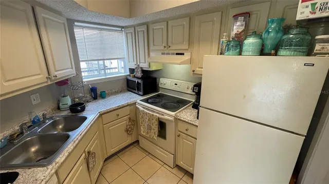 a kitchen with a sink appliances and cabinets