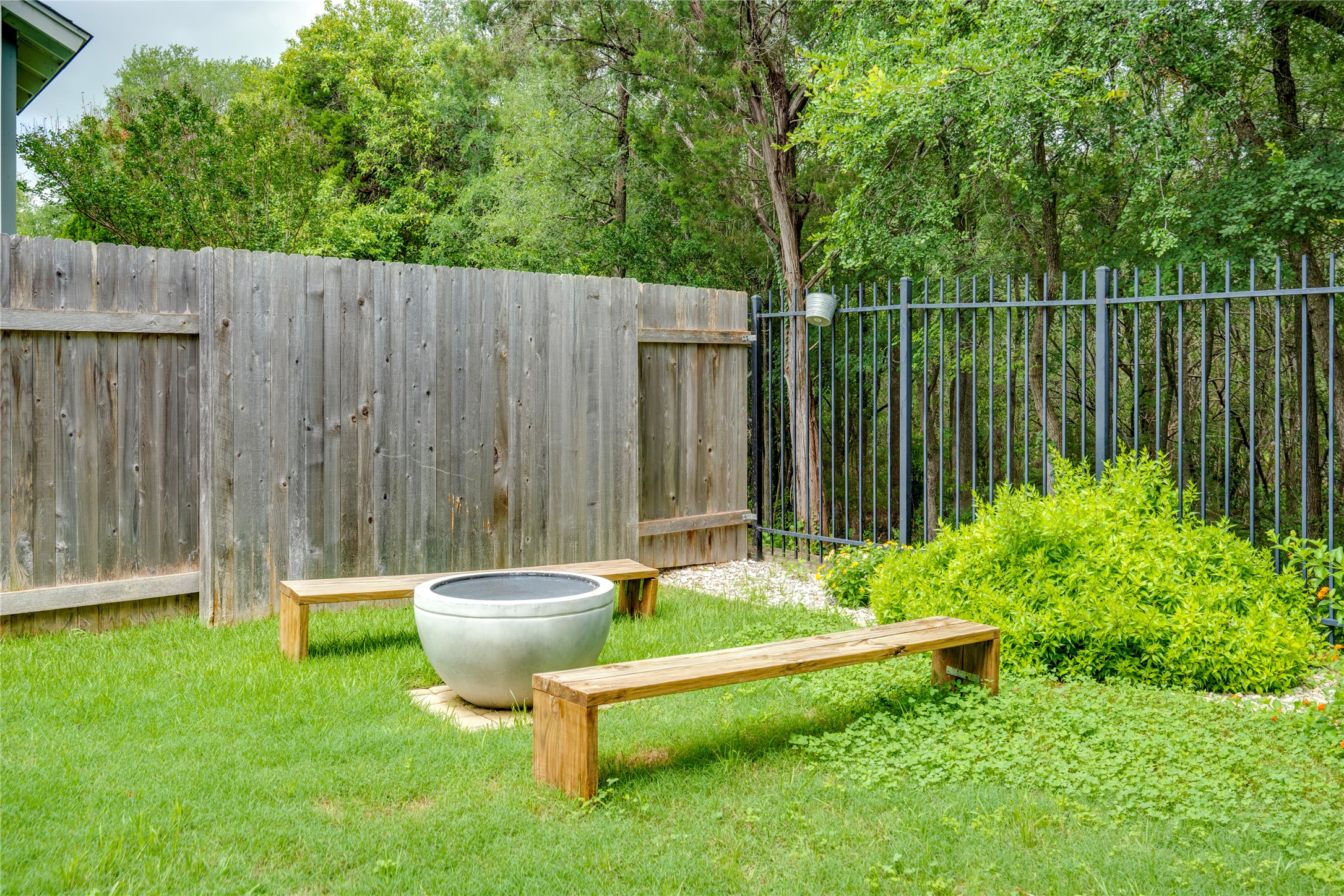 6008 Whipple Way Austin, TX 78745 - Photo 39 of 39 A well-maintained lawn with a privacy fence and a fire pit creates an inviting outdoor living space.