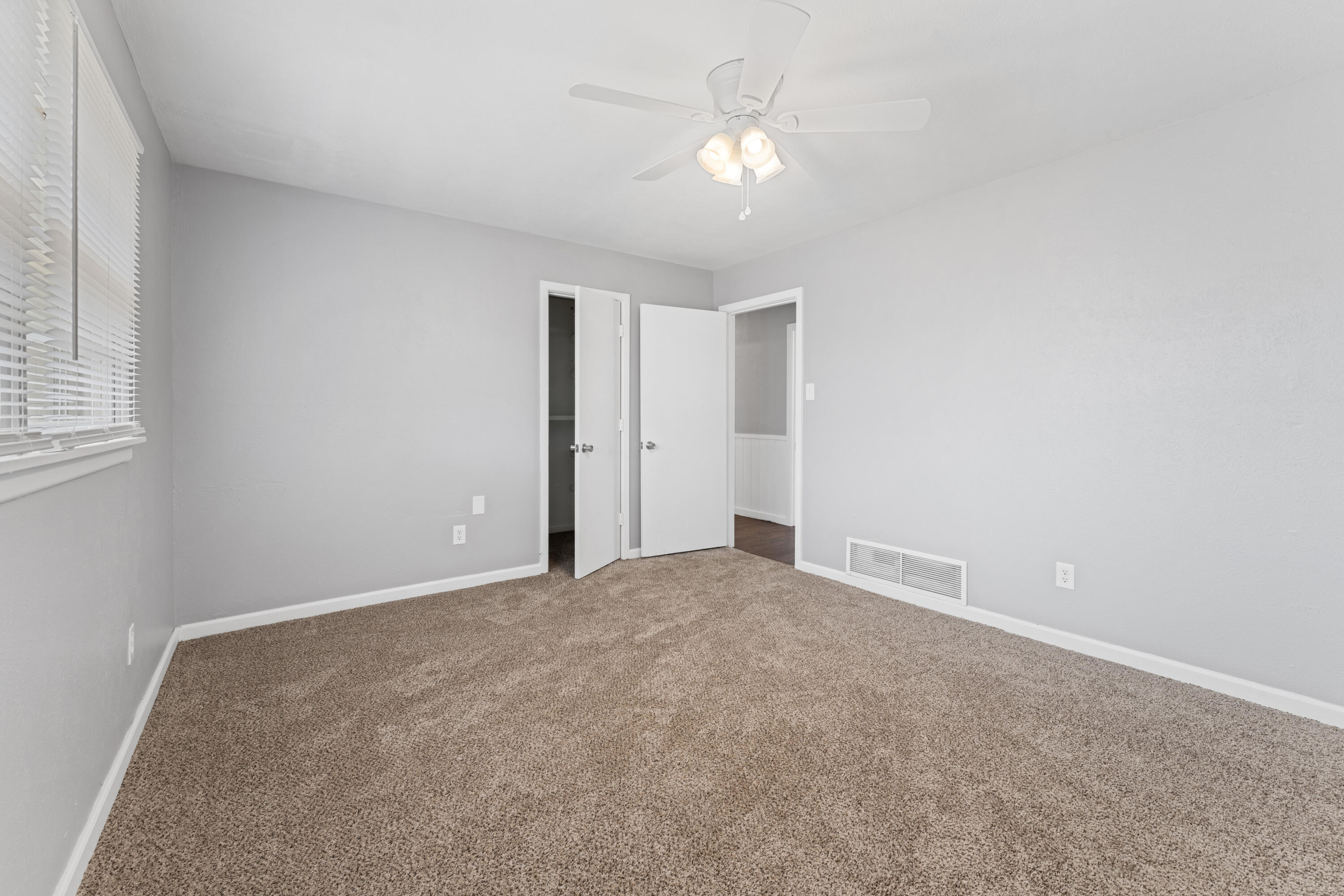 4609 31st Street Lubbock, TX 79410 - Photo 11 of 21 a view of a room with a ceiling fan and a window