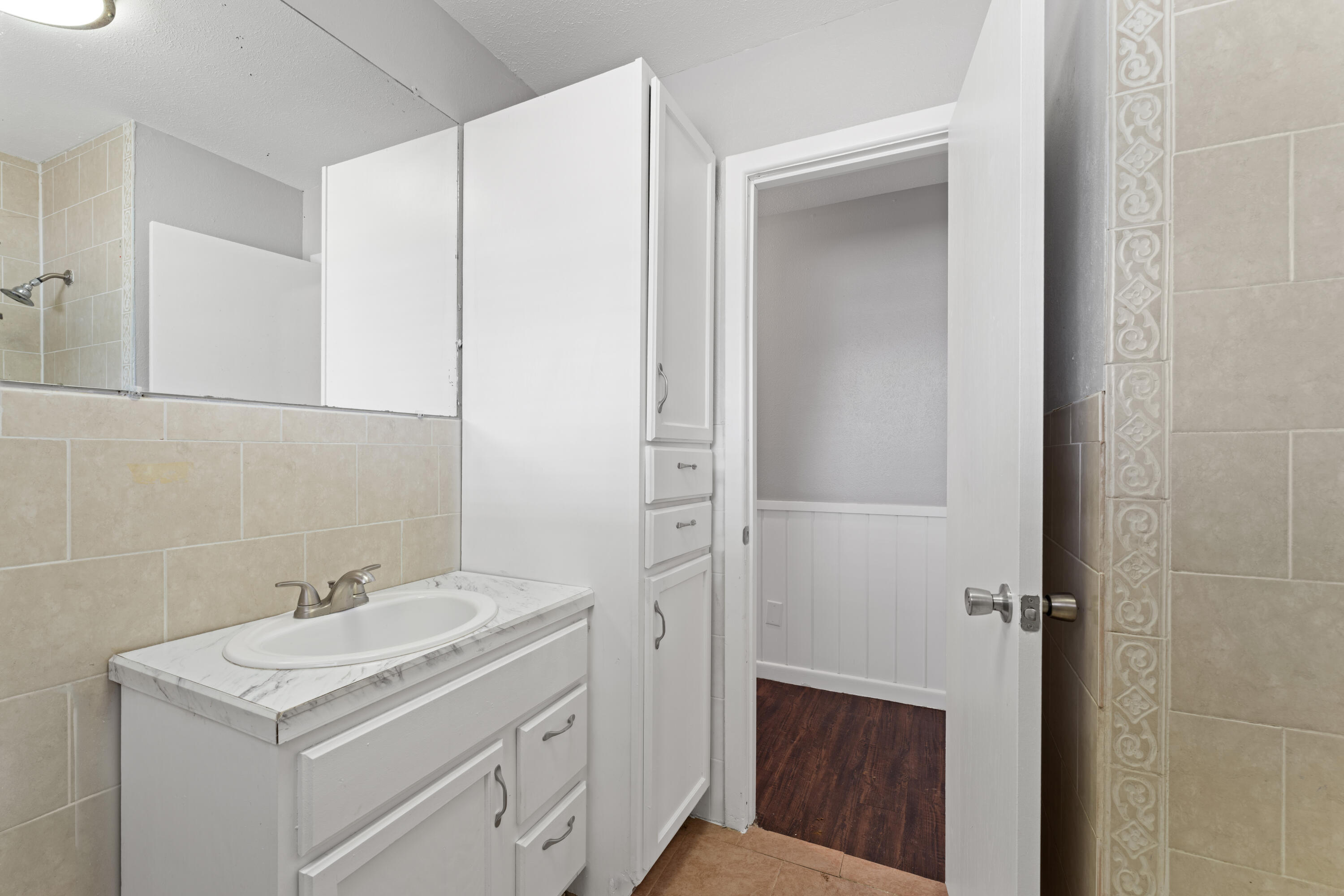 4609 31st Street Lubbock, TX 79410 - Photo 14 of 21 a bathroom with a sink a vanity and a mirror
