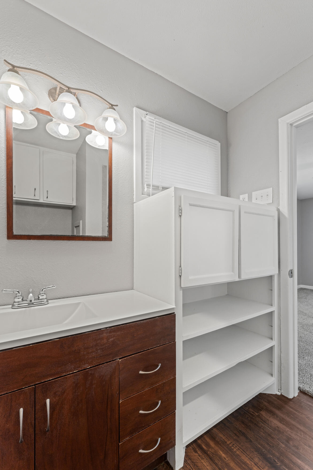 4609 31st Street Lubbock, TX 79410 - Photo 16 of 21 a bathroom with a sink vanity and mirror