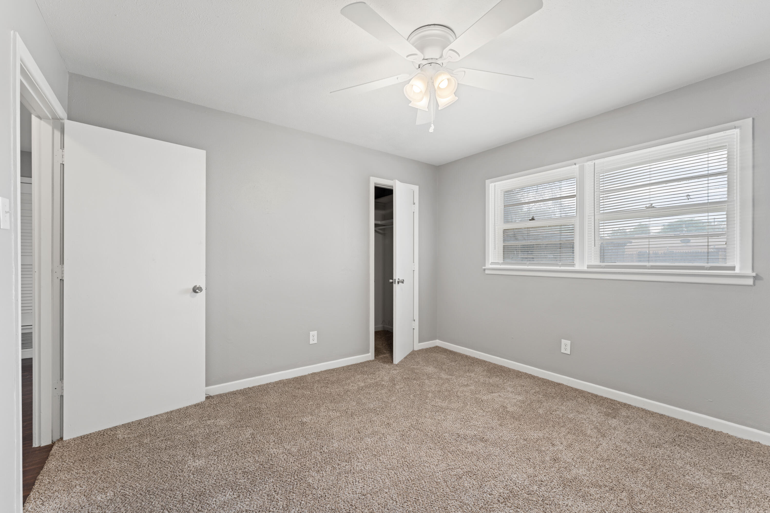 4609 31st Street Lubbock, TX 79410 - Photo 10 of 21 an empty room with windows and fan