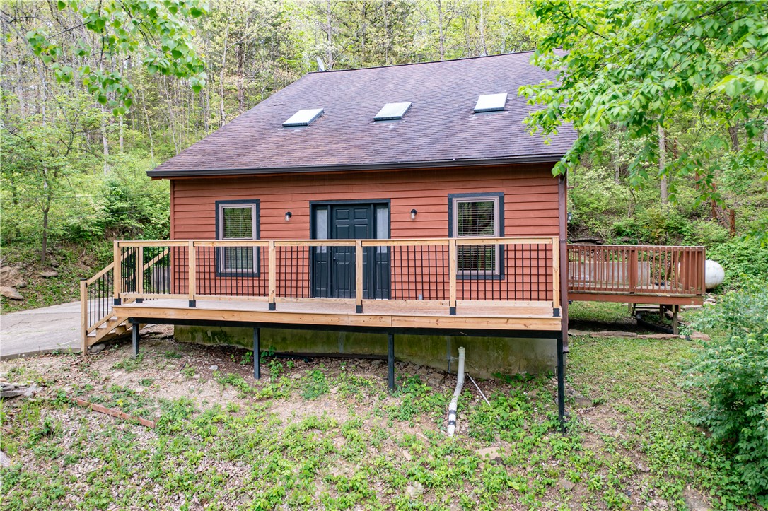 10584 New Biddinger Road Harrison, OH 45030 - Photo 58 of 61 This cozy woodland retreat features a spacious deck and modern skylights, blending comfort with nature.
