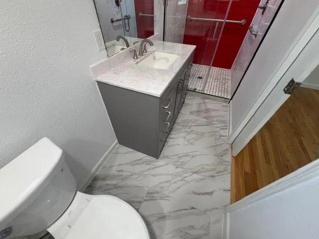 a bathroom with a sink toilet and mirror