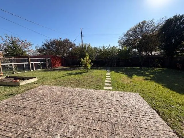 a view of a swimming pool with a yard