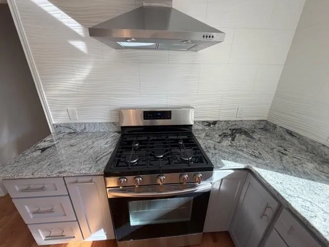 a stove top oven sitting inside of a kitchen