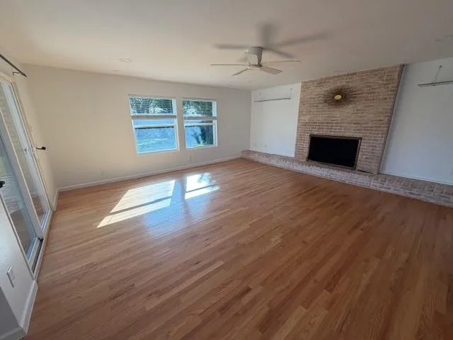 wooden floor in an empty room with a fireplace