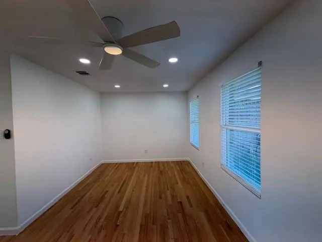 a view of a hallway with wooden floor