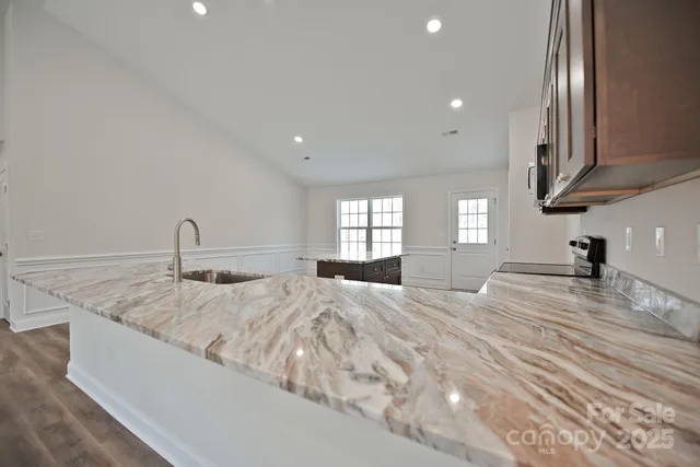 a view of a kitchen with a sink and cabinets