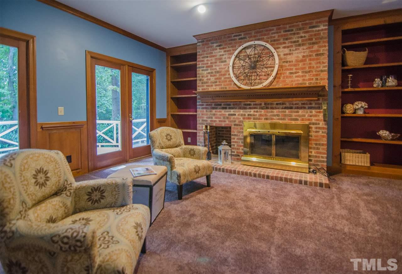1301 Cool Spring Road Raleigh, NC 27614 - Photo 6 of 25 Beautiful masonry fireplace with wood built-ins on either side. Notice the nook for firewood in the fireplace.