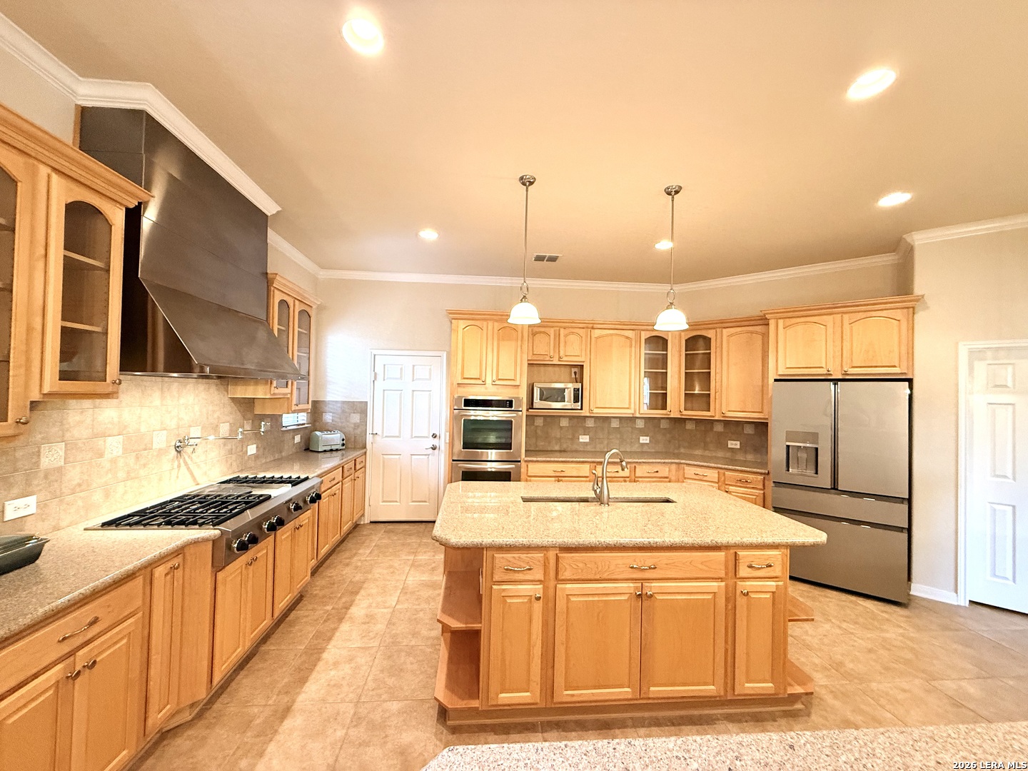 101 Rattlesnake Bluff Boerne, TX 78006 - Photo 13 of 28 a kitchen with stainless steel appliances kitchen island granite countertop a stove and a refrigerator