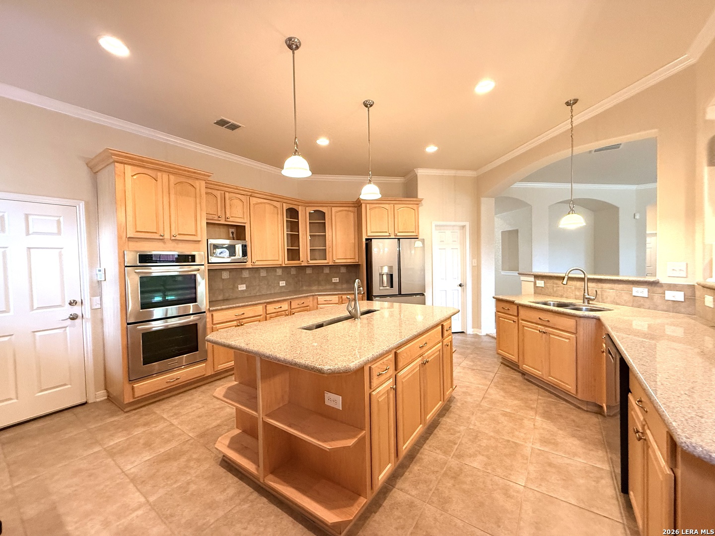 101 Rattlesnake Bluff Boerne, TX 78006 - Photo 14 of 28 a large kitchen with kitchen island a large counter top a stove a sink and a refrigerator