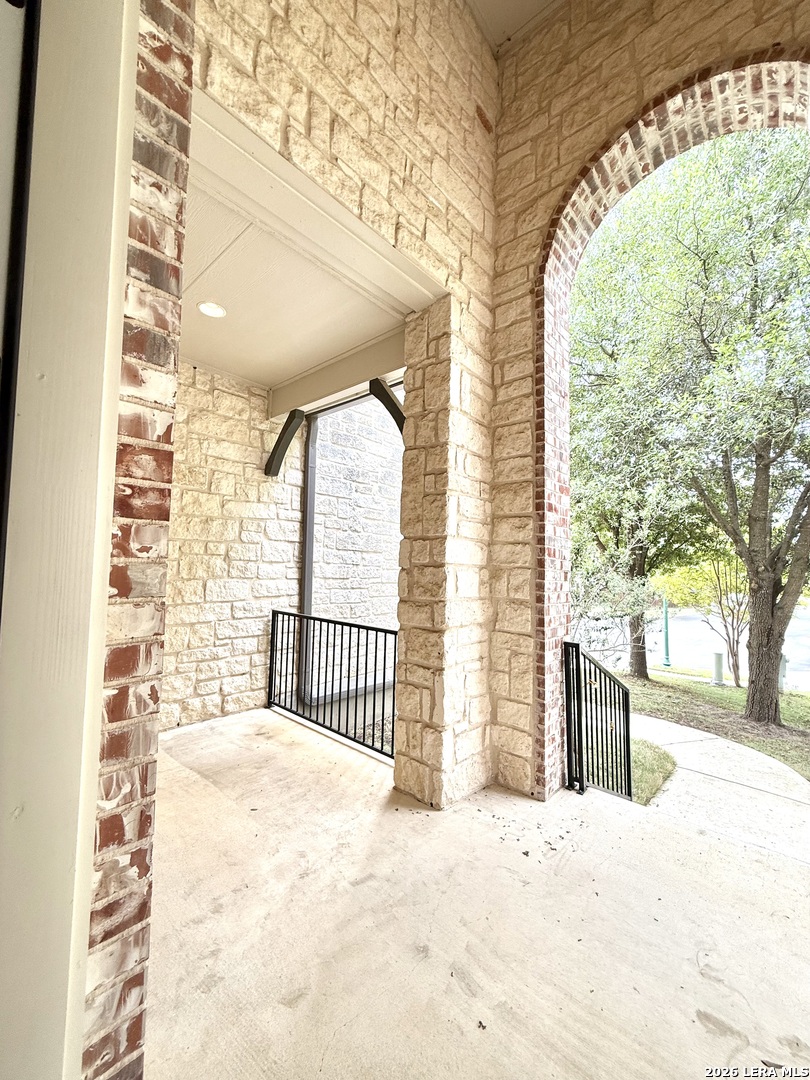 101 Rattlesnake Bluff Boerne, TX 78006 - Photo 28 of 28 a view of a porch with a floor to ceiling window and wooden fence