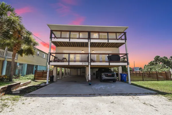 a view of a house with backyard porch and sitting area