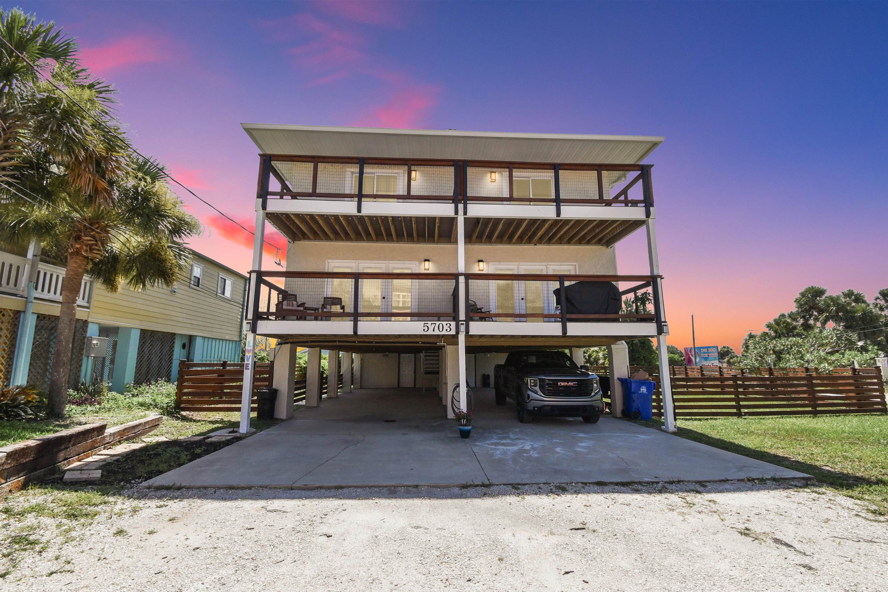 5703 Rudolph Avenue St. Augustine, FL 32080 - Photo 1 of 29 a view of a house with backyard porch and sitting area